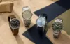 Four attainable automatic watch archetypes arranged on sand, navy and olive surfaces